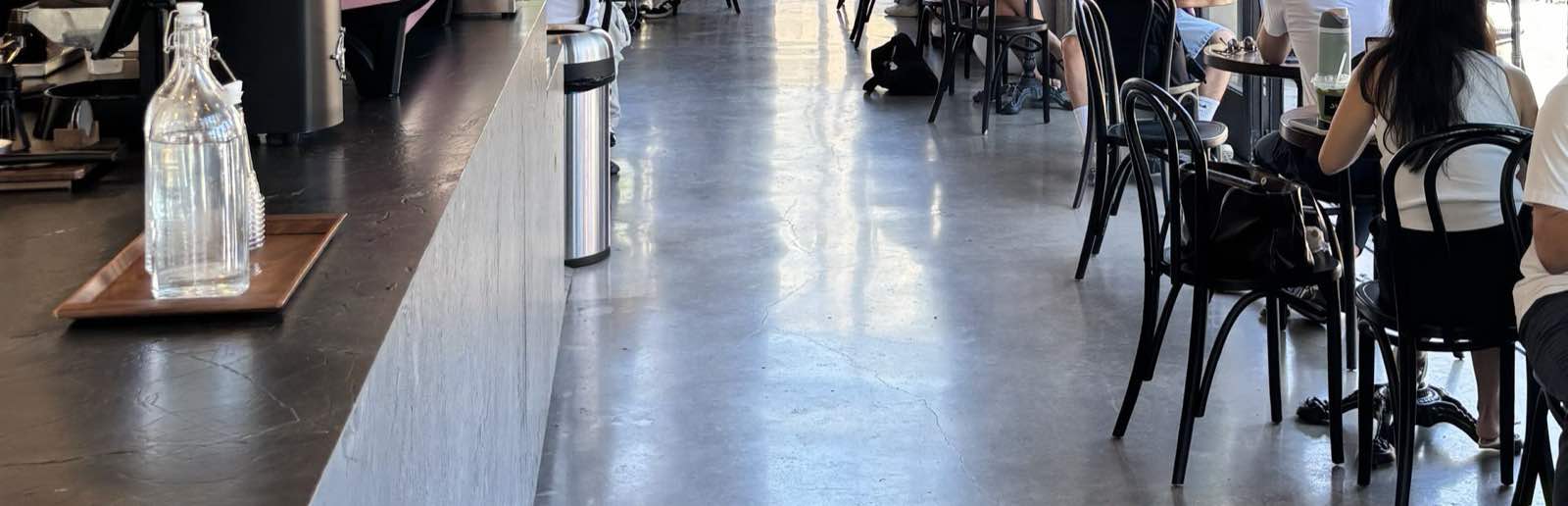 A café in Los Angeles on a weekday afternoon, tables full of people working on laptops.
